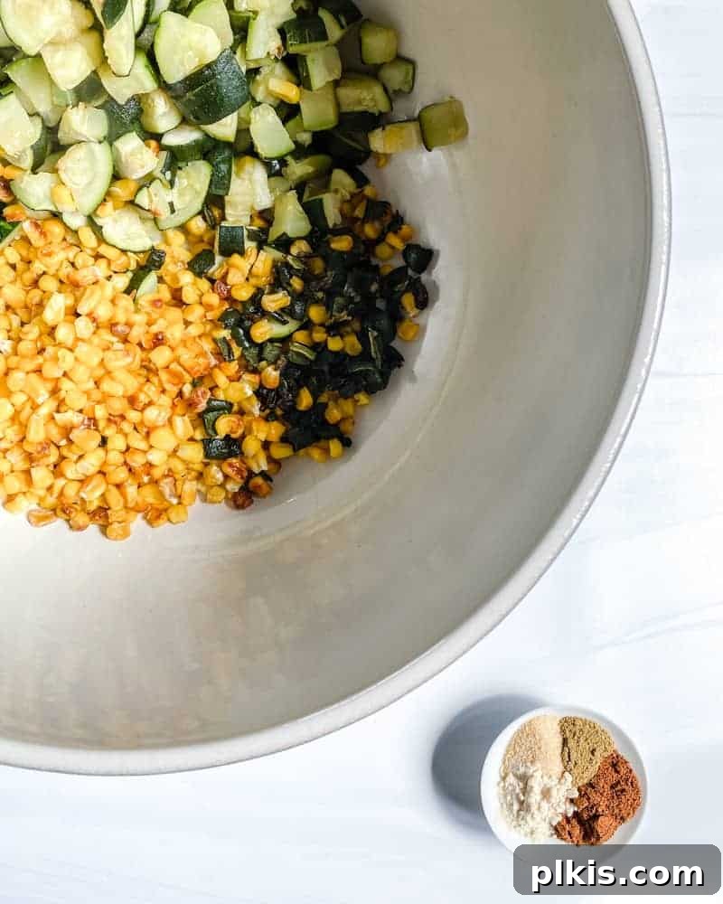 Roasted Harvest Tacos 10 various roasted vegetables in a white bowl against a white background.