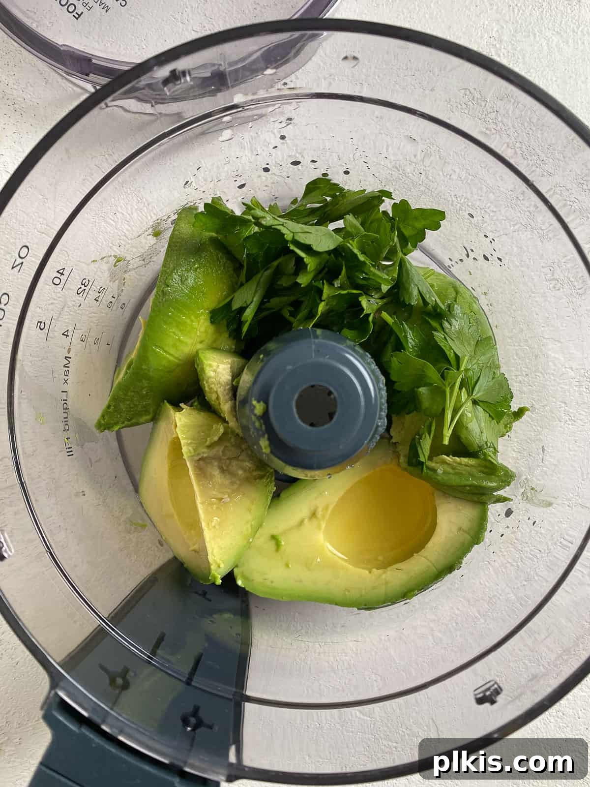 Effortless Avocado Cream 4 Process of adding ingredients to food processor.