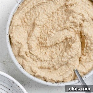completed Vegan French Onion Dip in a white bowl against a light background