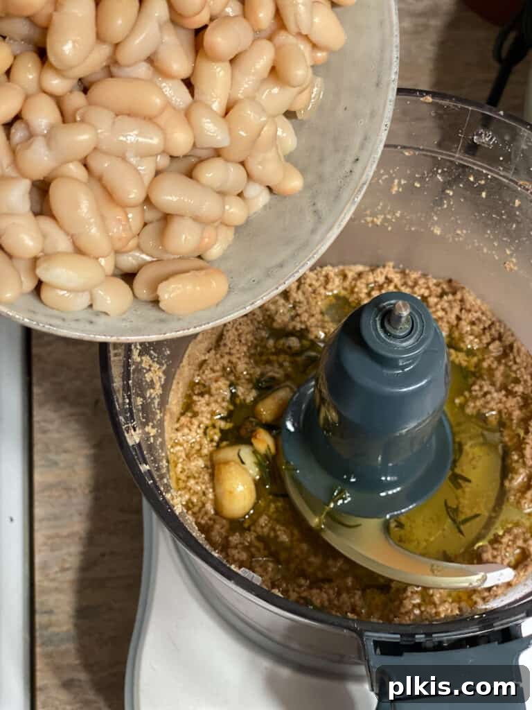 Plant-Powered Bean Dip 11 process shot of adding beans to food processor