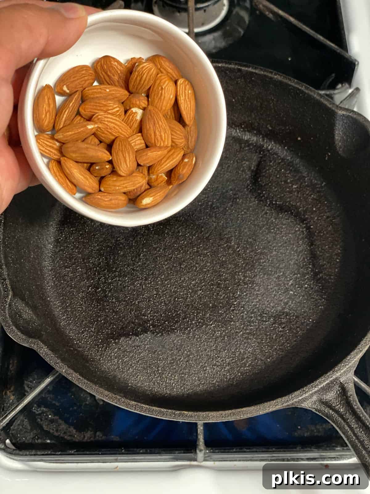 Plant-Powered Bean Dip 4 process shot of adding almonds to pan