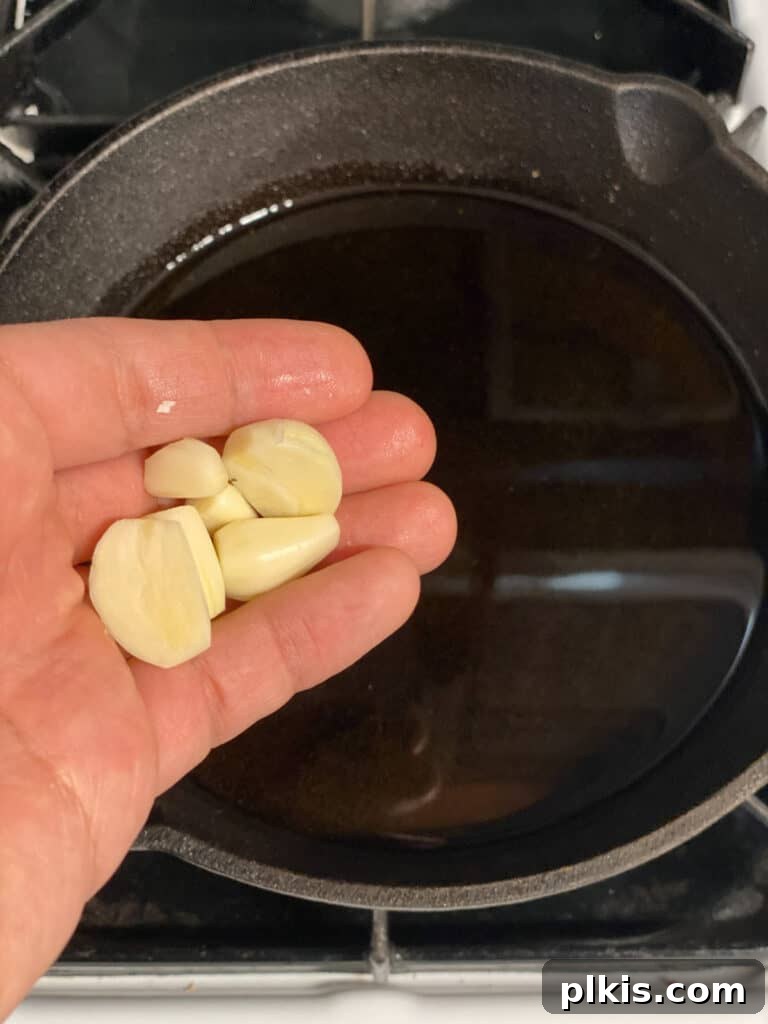 Plant-Powered Bean Dip 7 process shot of adding garlic to pan