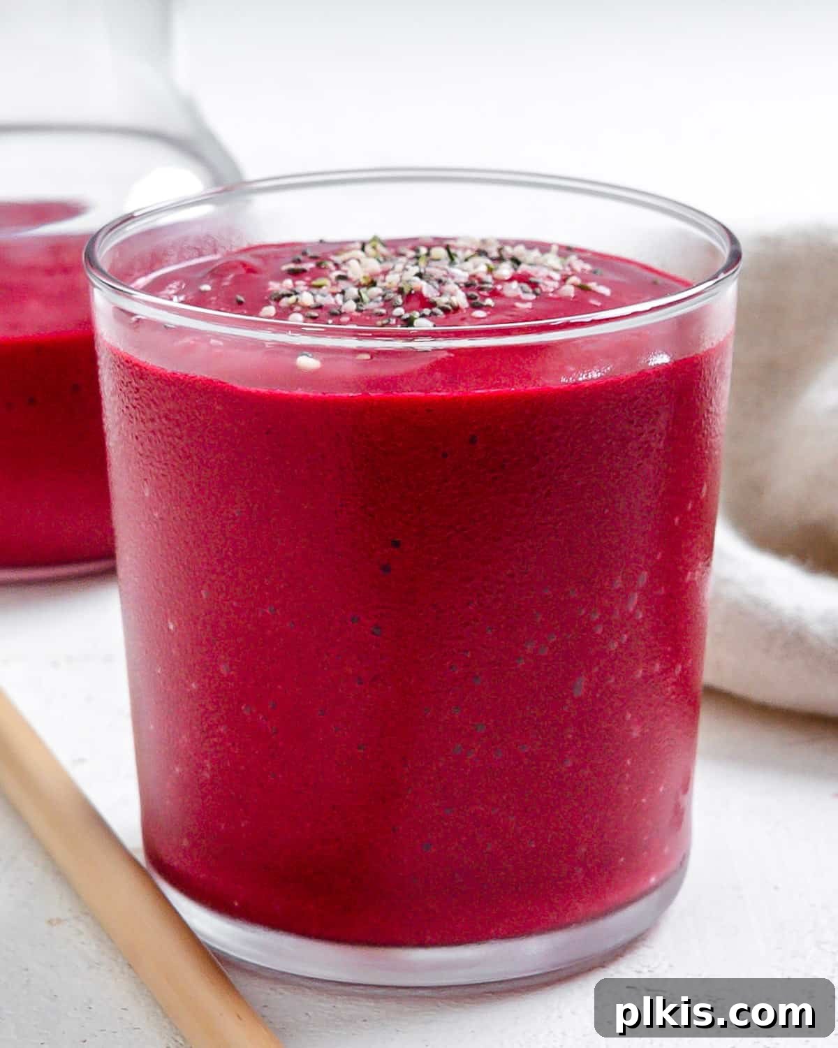 Ruby Red Beet & Banana Bliss 2 A refreshing Banana Beet Smoothie served in a tall glass cup, set against a bright, airy background, highlighting its beautiful vibrant color.