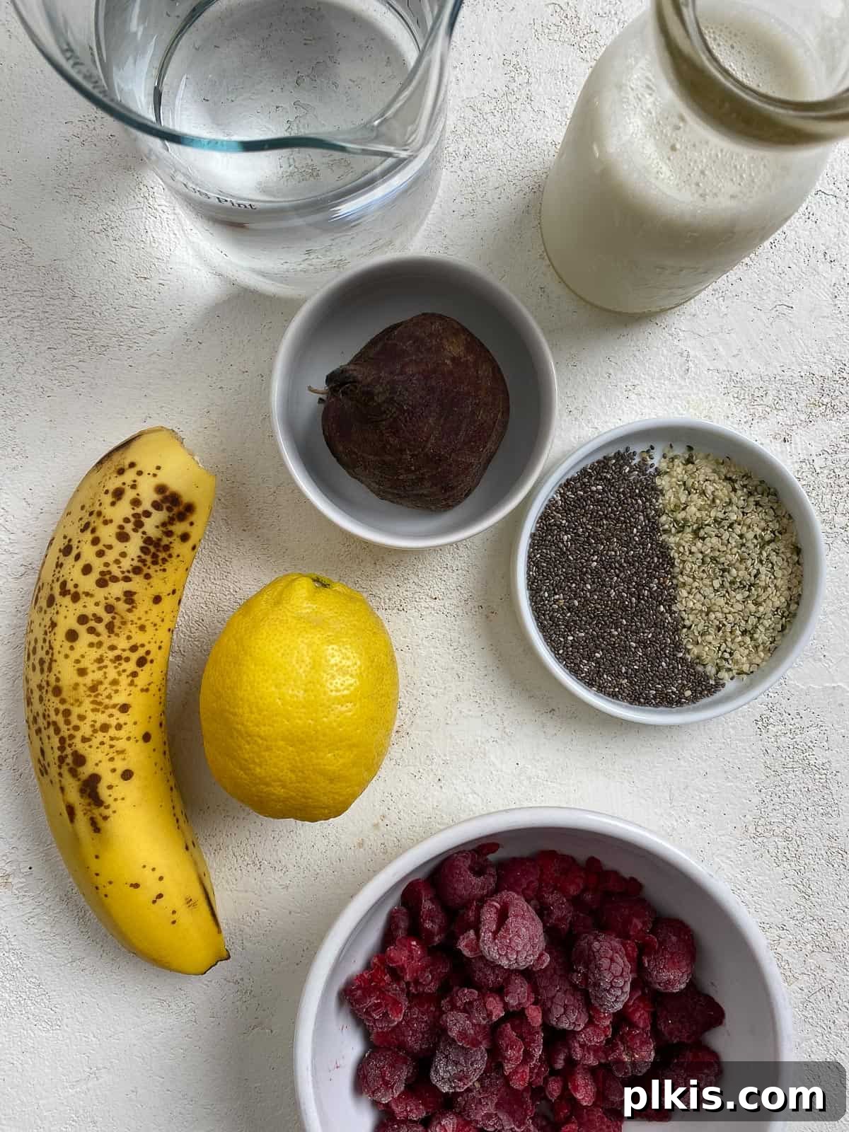 Ruby Red Beet & Banana Bliss 3 All the fresh and frozen ingredients for the Banana Beet Smoothie, neatly measured and arranged on a clean white surface, ready for blending.