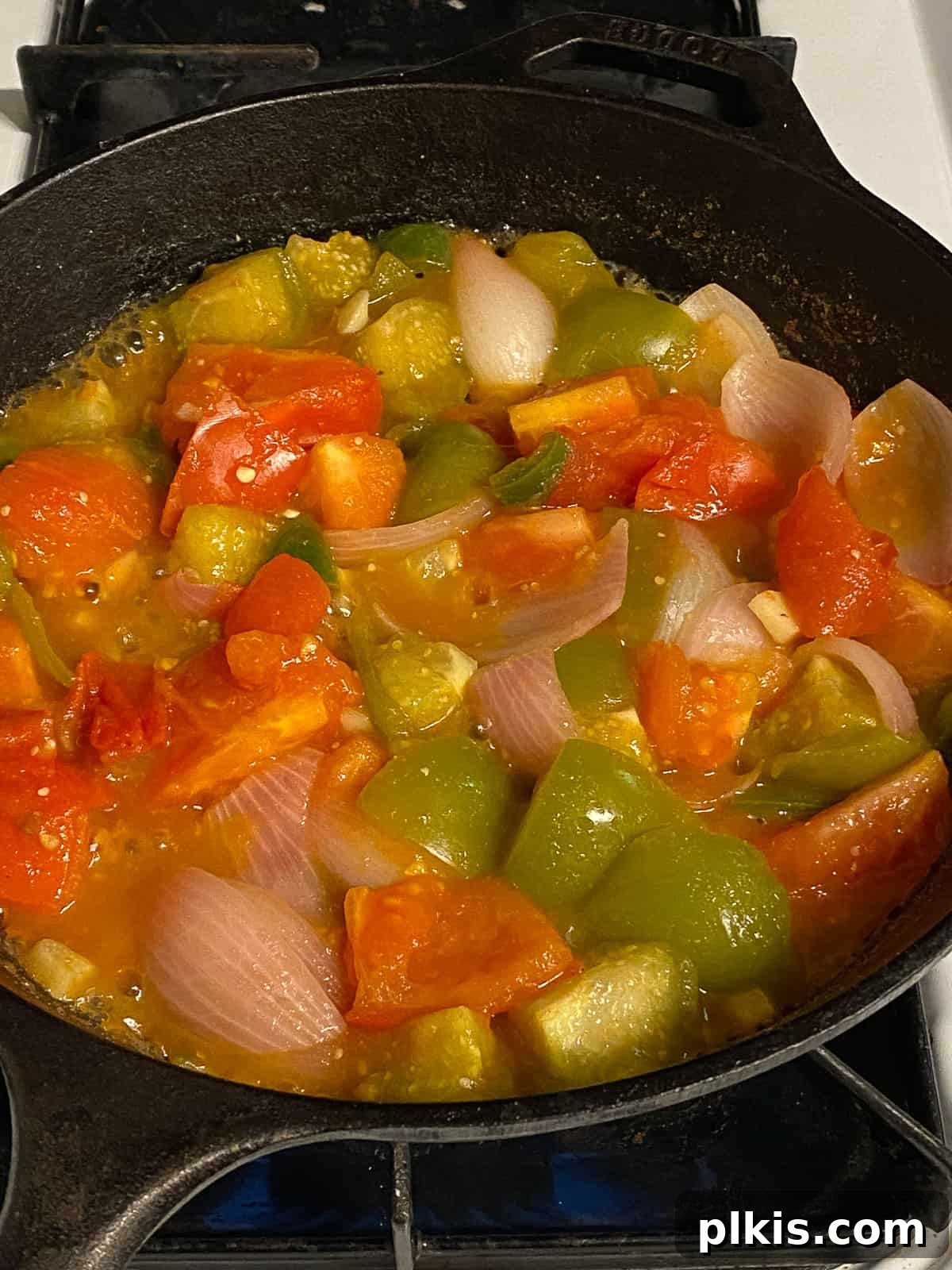 Zesty Tomatillo Green Chili Salsa 9 Vegetables simmering in a saucepan on the stovetop, cooking down for tomatillo salsa.