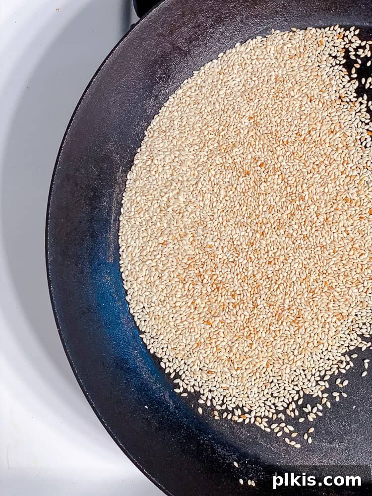 Process shot showing sesame seeds in pan.