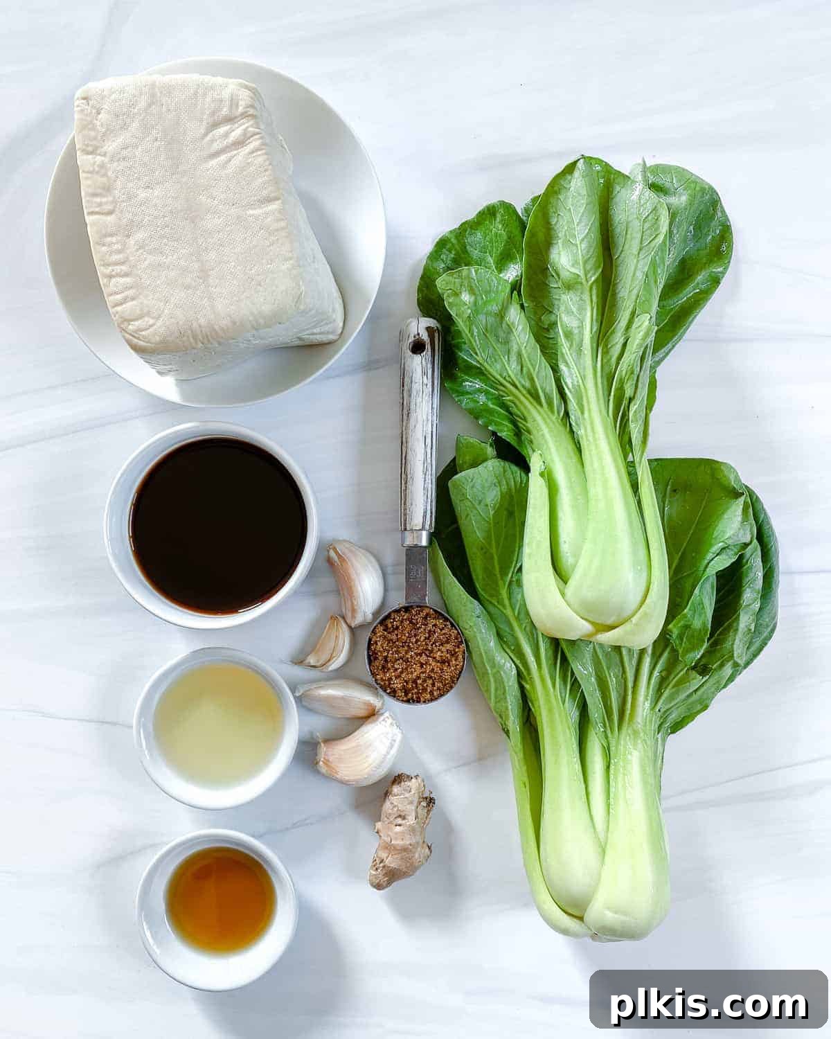Sweet and Spicy Tofu Stir-Fry 3 Various ingredients for Spicy and Sweet Tofu laid out against a clean white background.