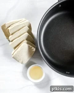 Close-up of raw tofu fillets before frying, arranged neatly.