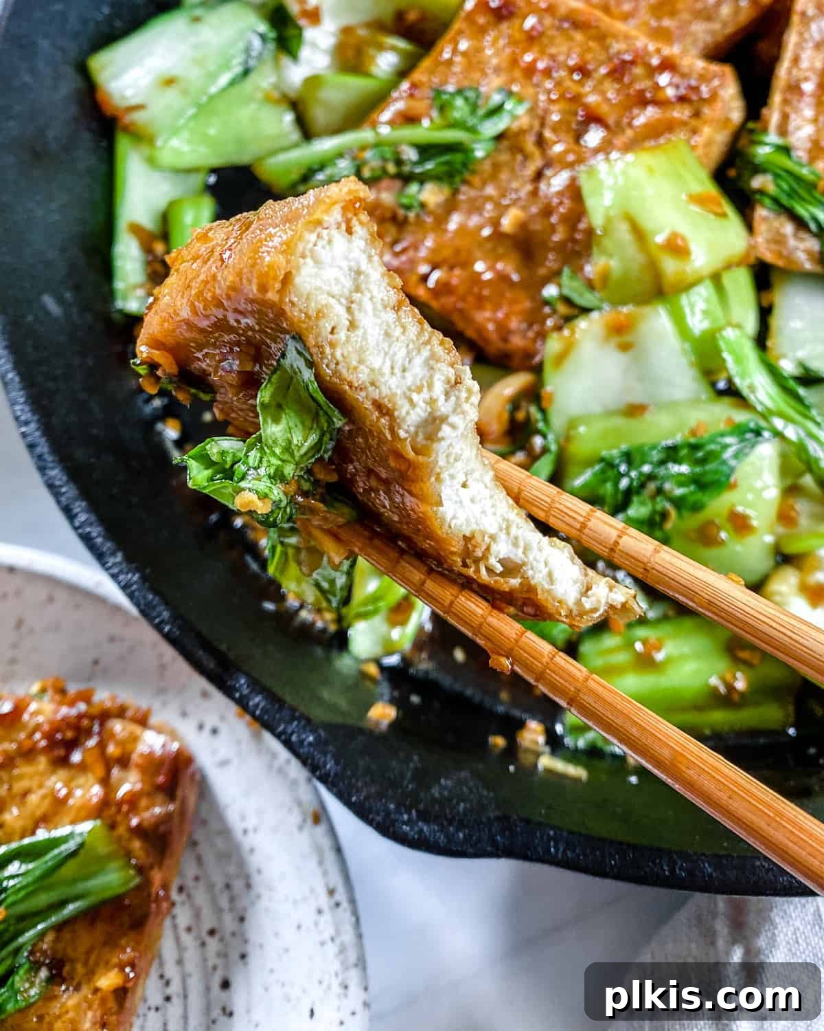 Sweet and Spicy Tofu Stir-Fry 10 Close-up of the completed Spicy and Sweet Tofu in an iron skillet, showcasing its texture and glaze.