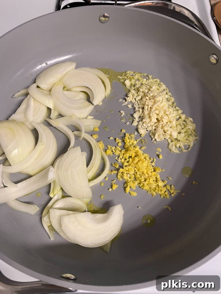Velvet Rice Noodle Stir Fry 6 process shot of onion ginger and garlic being cooked in pan