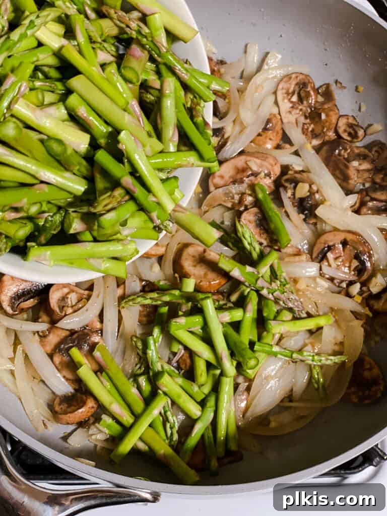 Velvet Rice Noodle Stir Fry 8 process shot of asparagus being added to pan