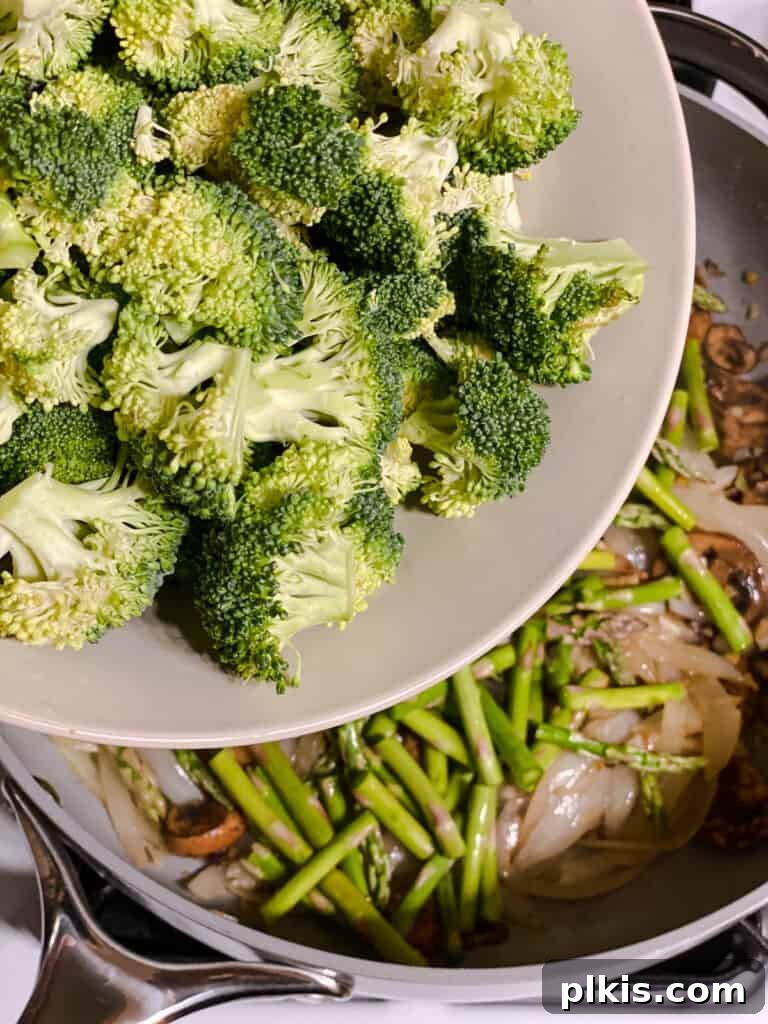 Velvet Rice Noodle Stir Fry 9 process shot of broccoli being added to pan