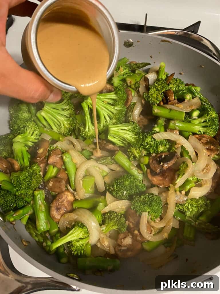 Velvet Rice Noodle Stir Fry 10 process shot of adding taihni to pan