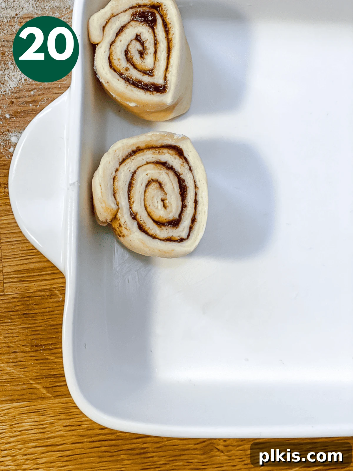 Heavenly Vegan Cinnamon Rolls 23 Placing unbaked cinnamon rolls, spaced apart, into a white baking dish.