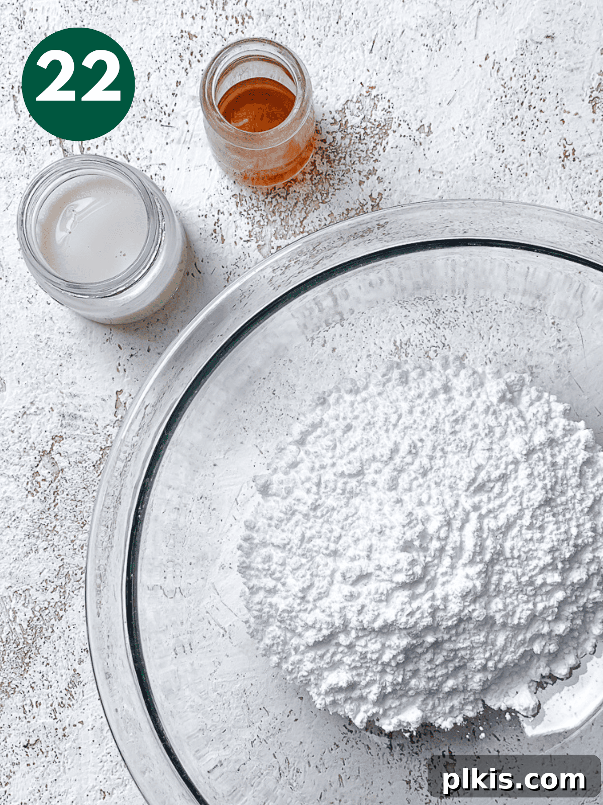 Heavenly Vegan Cinnamon Rolls 25 Ingredients for vanilla icing (powdered sugar, plant milk, vanilla extract, salt) in small glass bowls and jars.