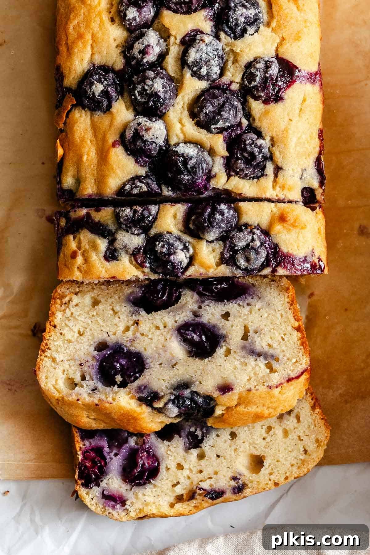 Completed Easy Blueberry Bread [Quick Bread!] on a cutting board, ready to be served.