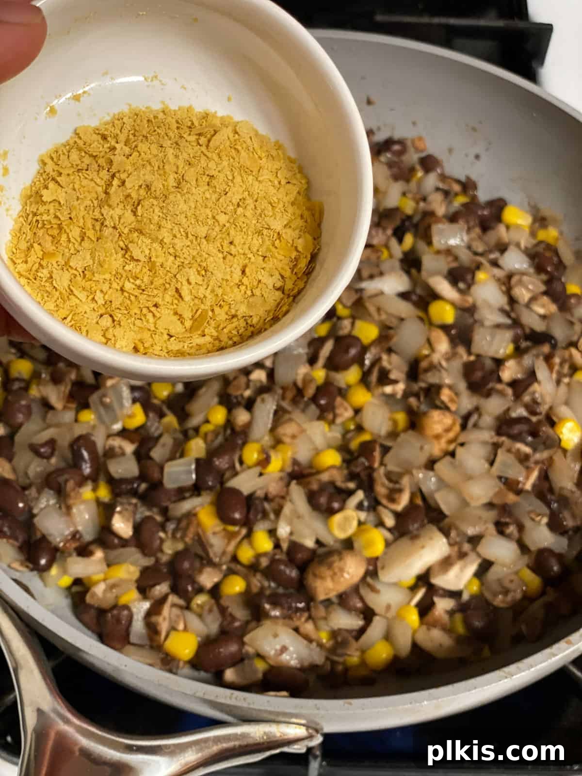 Double the Deliciousness: Vegan Black Bean Tacos 5 process shot of nutritional yeast being added to bowl