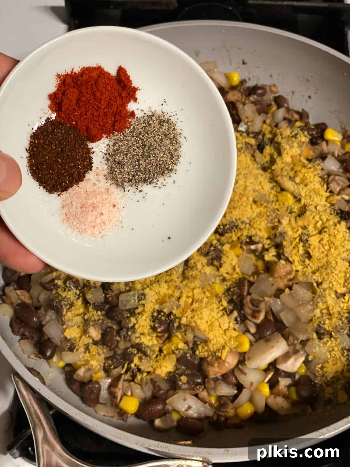 Double the Deliciousness: Vegan Black Bean Tacos 6 process shot of spices being added to bowl
