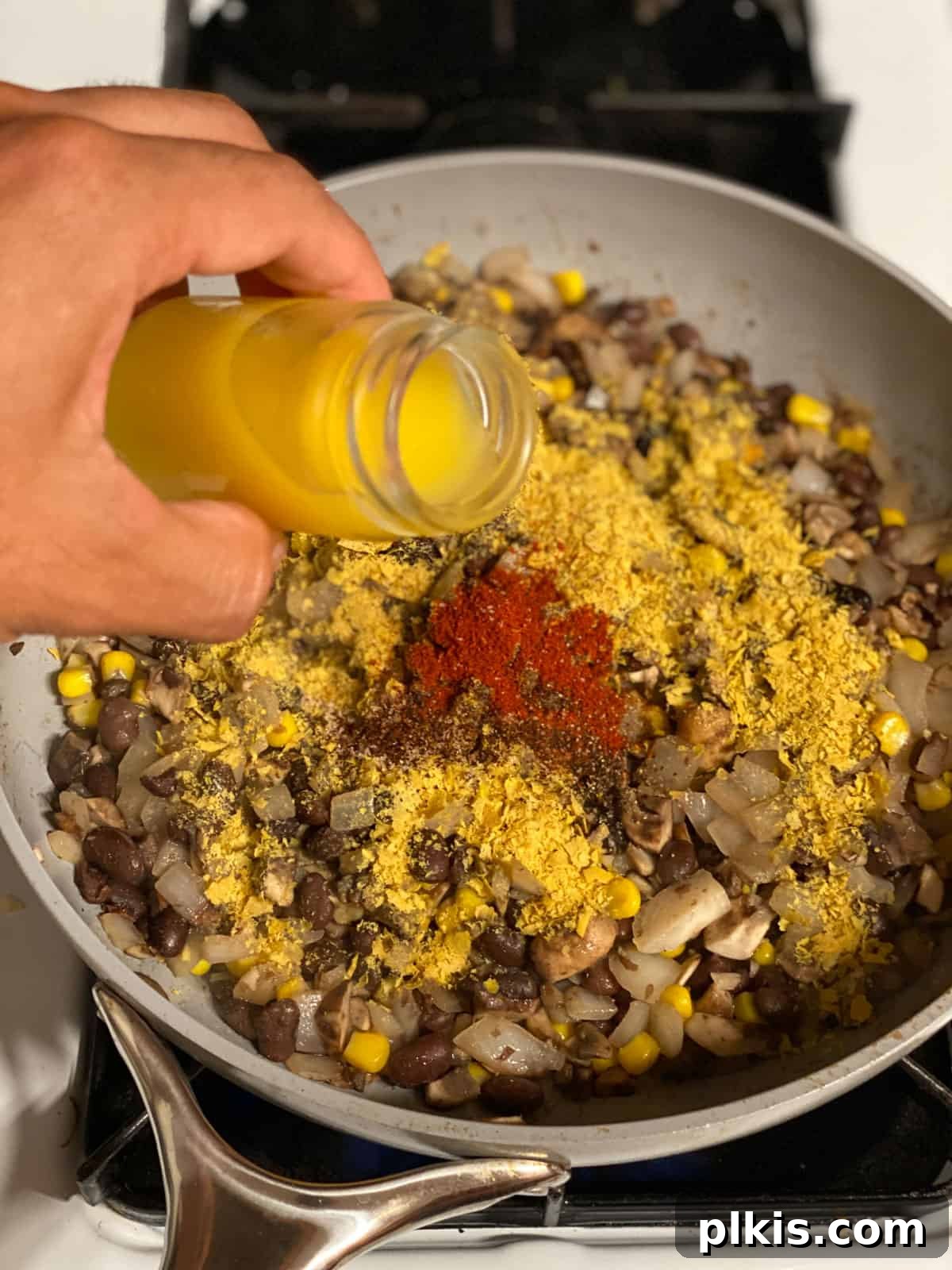 Double the Deliciousness: Vegan Black Bean Tacos 7 process shot of orange juice being added to bowl
