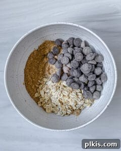 process of combining Chocolate Chip Banana Bites ingredients to bowl