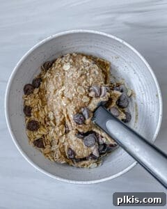 process of stirring Chocolate Chip Banana Bites ingredients in bowl
