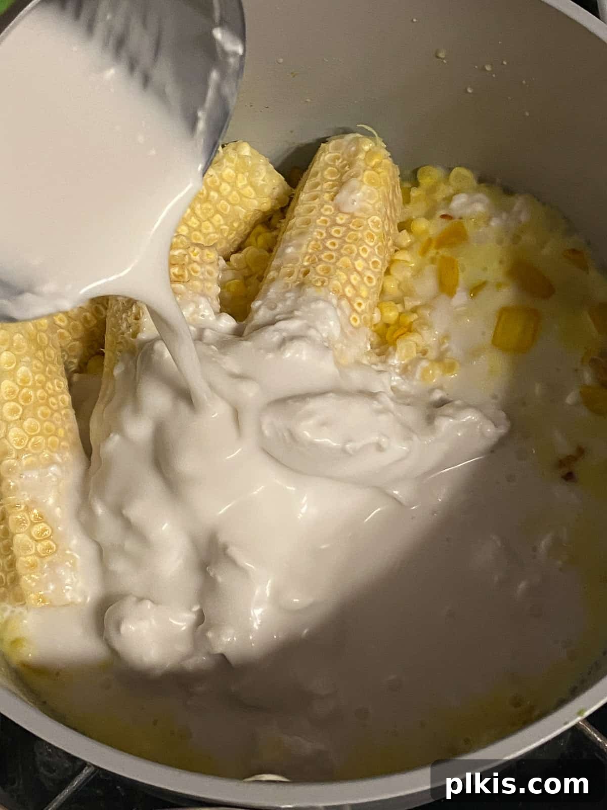 Velvety Vegan Coconut Corn Chowder 11 Step 2: Pouring rich coconut milk into the corn chowder base.