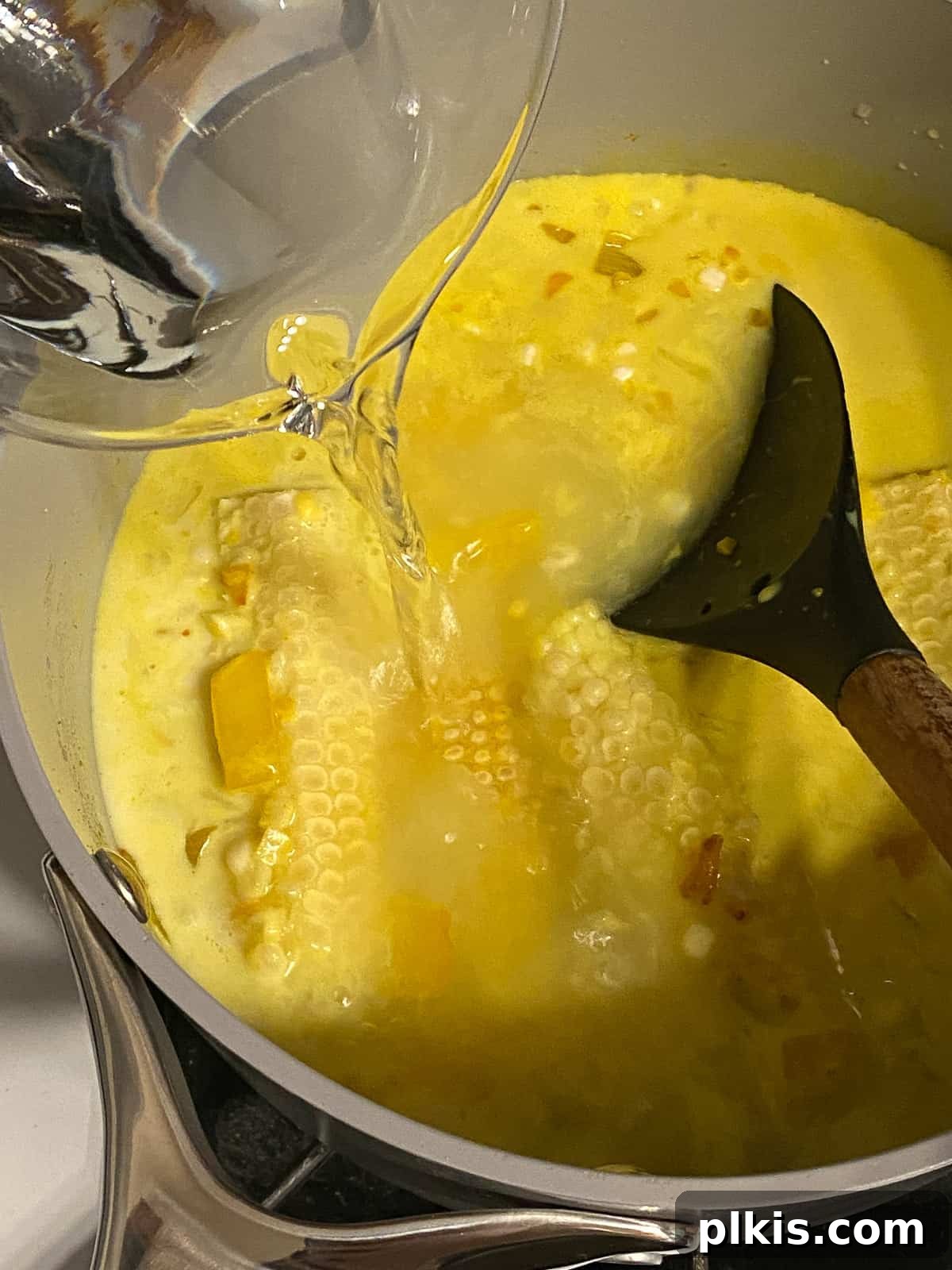 Velvety Vegan Coconut Corn Chowder 12 Step 2: Adding water to the chowder ingredients in the pot.
