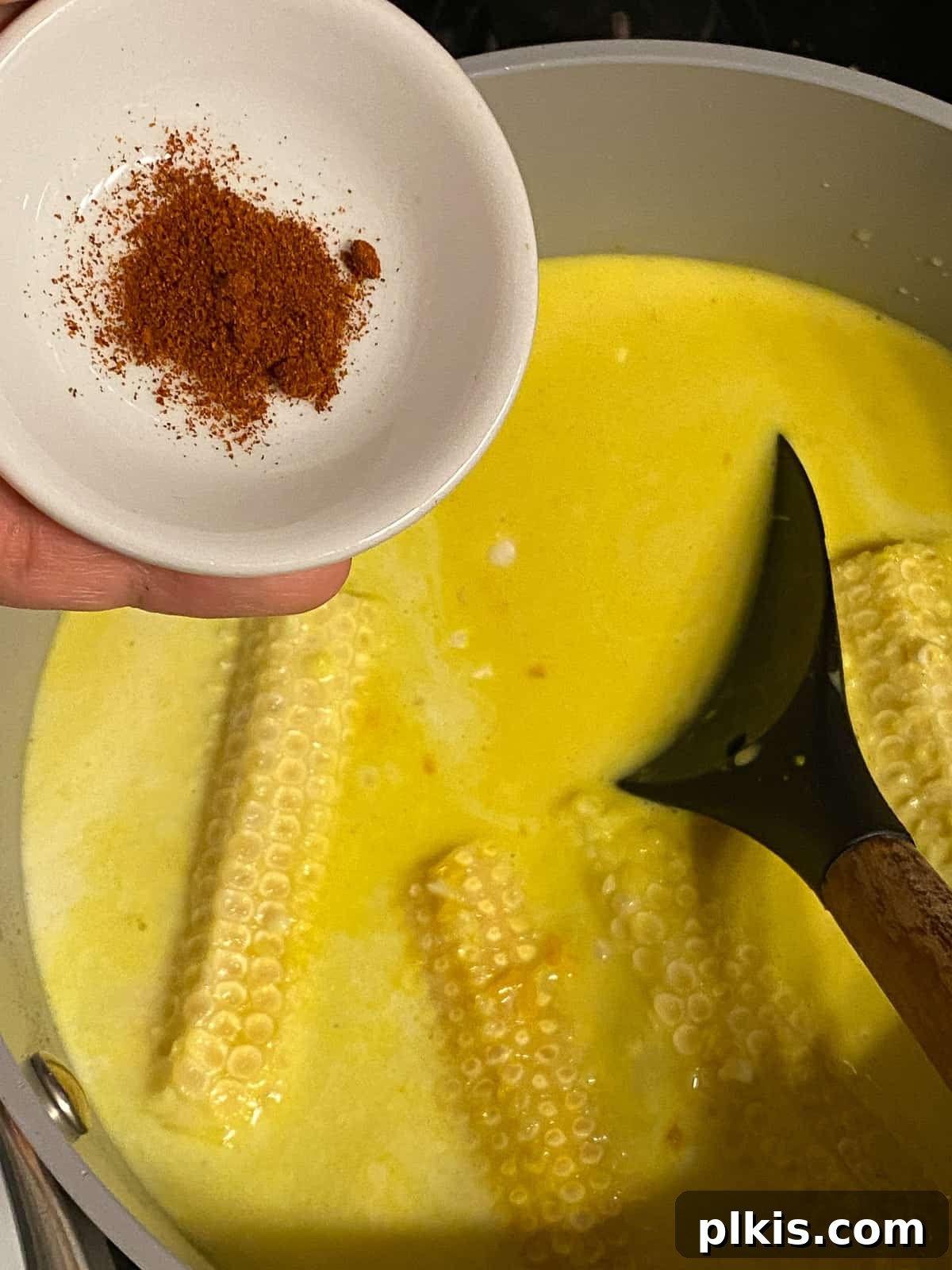 Velvety Vegan Coconut Corn Chowder 14 Step 2: Adding a pinch of cayenne pepper for warmth and spice.