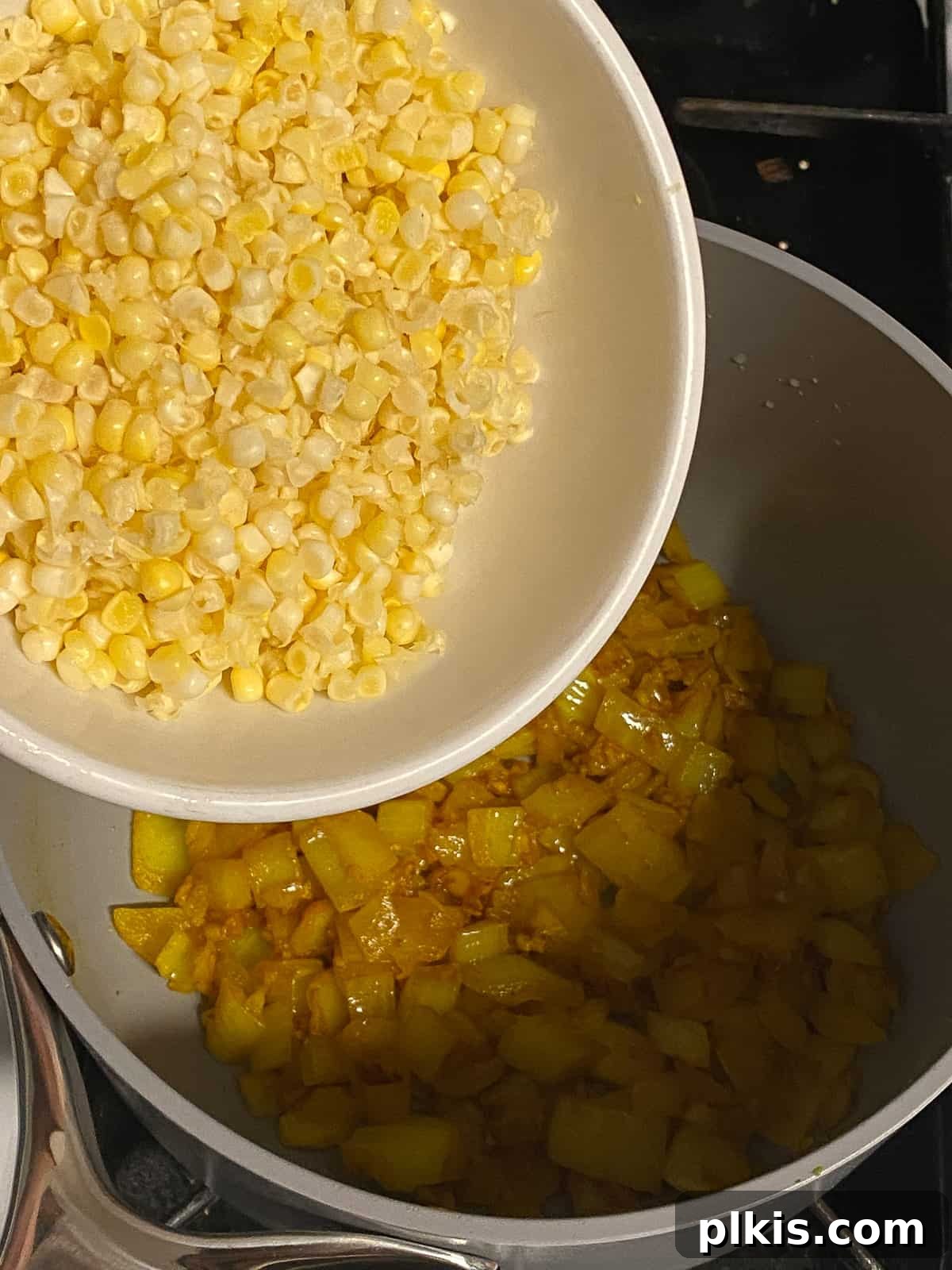Velvety Vegan Coconut Corn Chowder 9 Step 2: Adding fresh corn kernels to the pot.