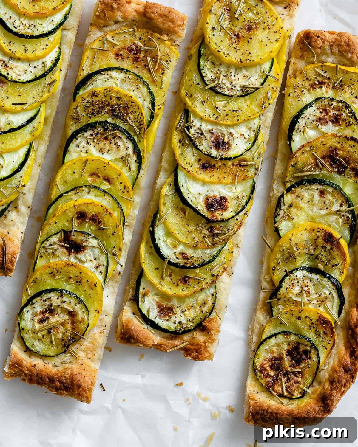 Vibrant Zucchini Tart 12 A beautifully baked and perfectly sliced vegan zucchini tart, highlighting its golden crust and tender vegetable topping.