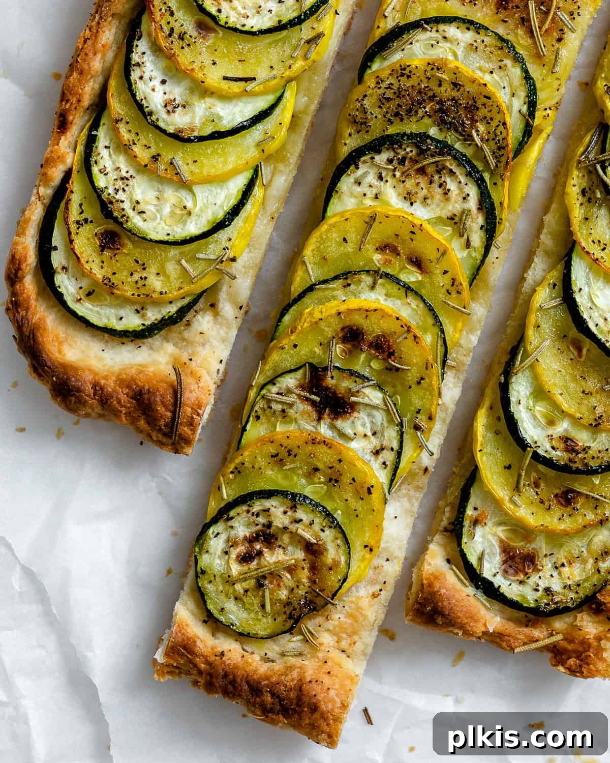 Vibrant Zucchini Tart 13 Multiple slices of a freshly baked vegan zucchini tart arranged on a serving platter, ready to be enjoyed.