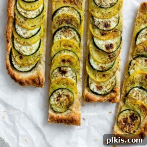 A freshly baked and sliced zucchini tart, beautifully golden and ready to serve.