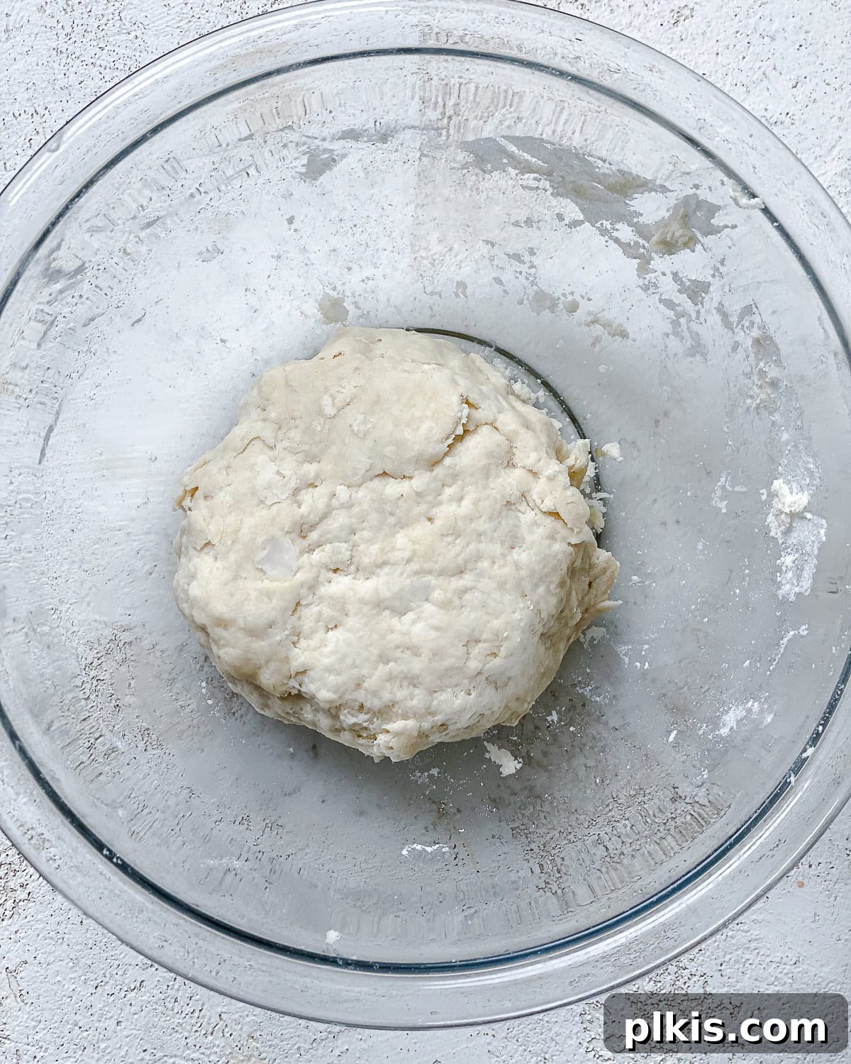 Vibrant Zucchini Tart 7 A perfectly formed smooth ball of tart dough resting in a clear glass bowl, ready for pressing.