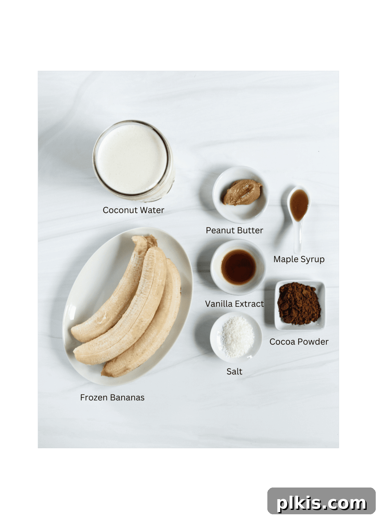 Chocolate Peanut Butter Banana Dream 3 Ingredients for Chocolate Peanut Butter Banana Smoothie laid out on a white surface