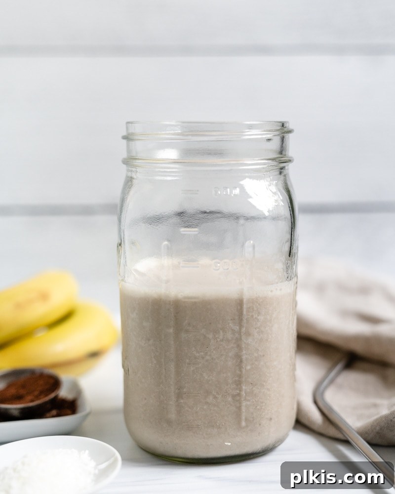 Chocolate Peanut Butter Banana Dream 4 Plain blended banana smoothie in a jar against a white background, ready for the chocolate layer