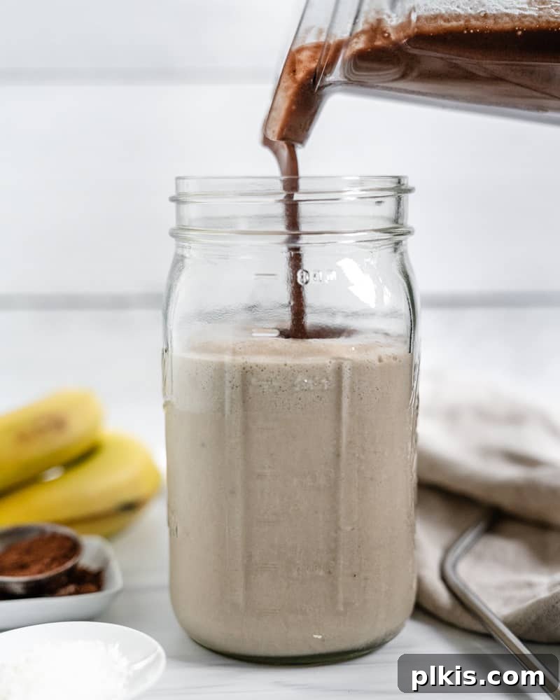 Chocolate Peanut Butter Banana Dream 5 Process shot of adding the plain blended mixture to a jar, leaving some in the blender for the chocolate layer