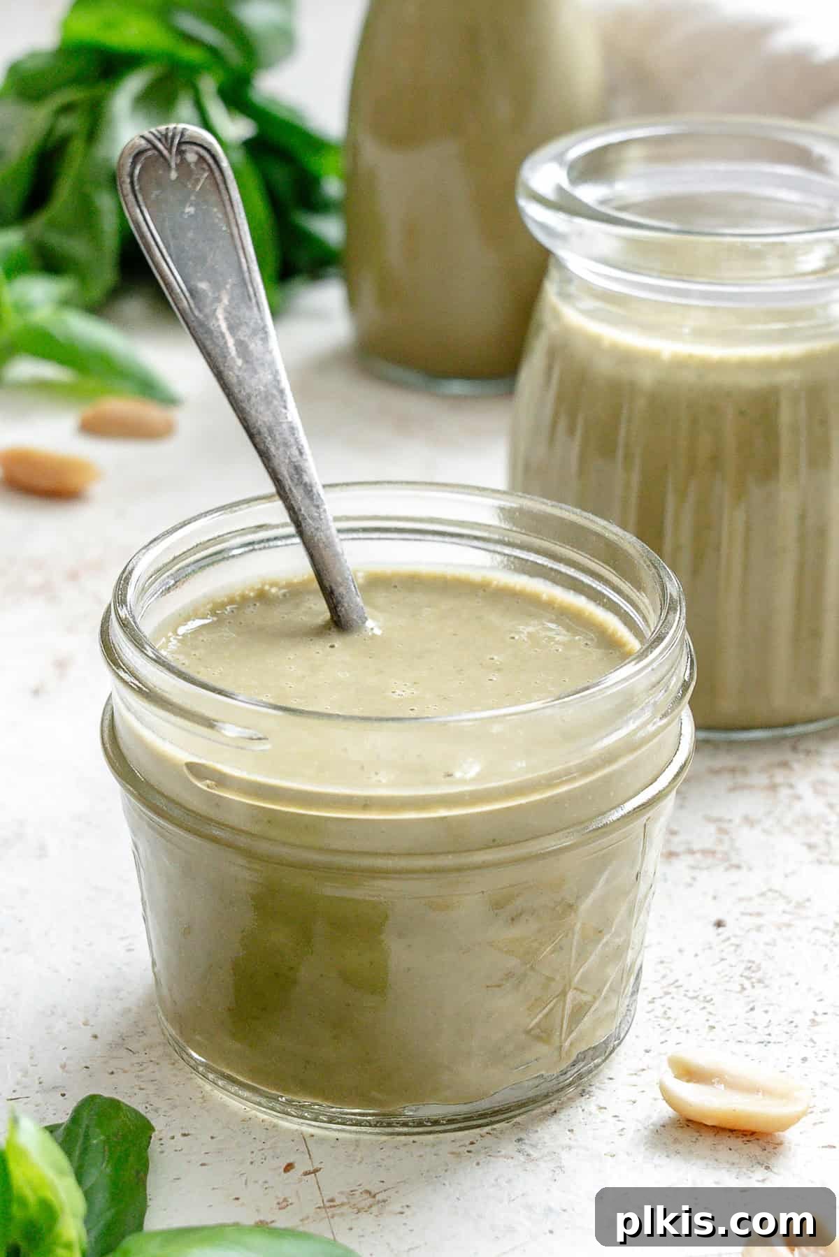 Vibrant Basil Vinaigrette 2 Completed Basil Salad Dressing in two jars.