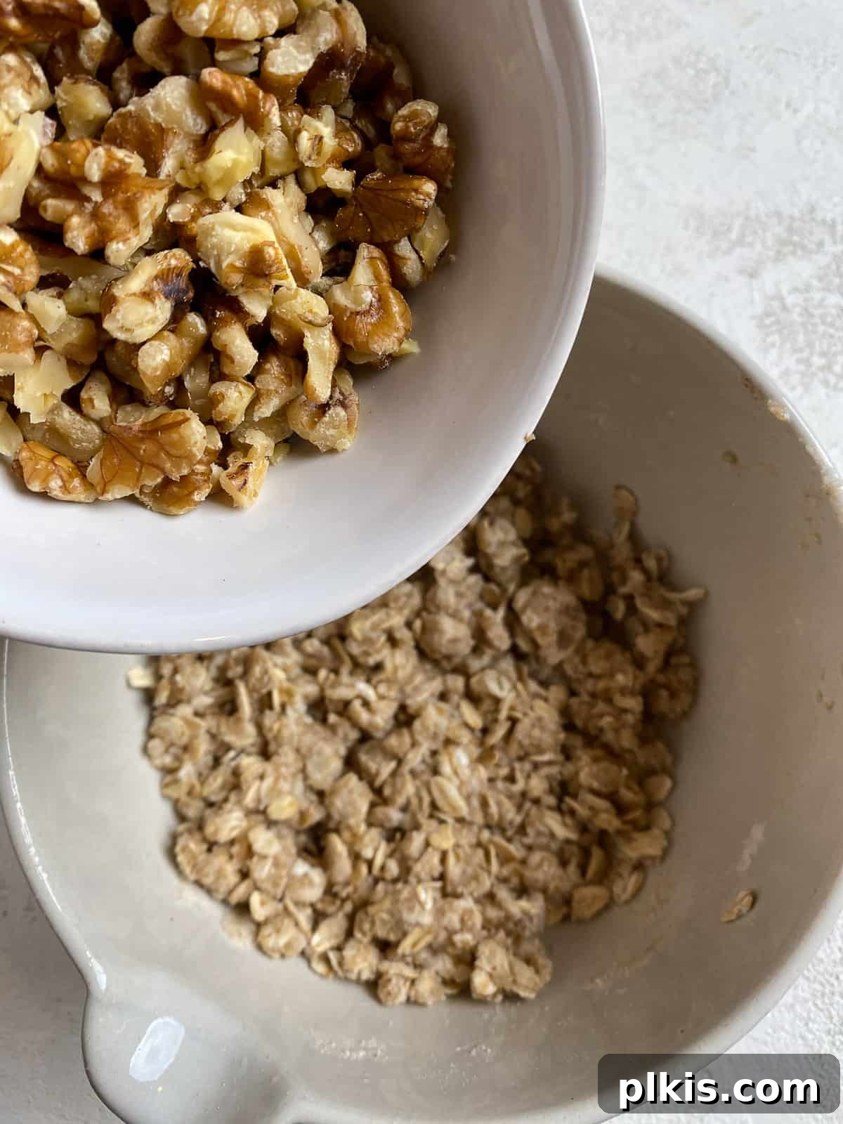 process of adding mixed nuts to peach crumb pie mixture