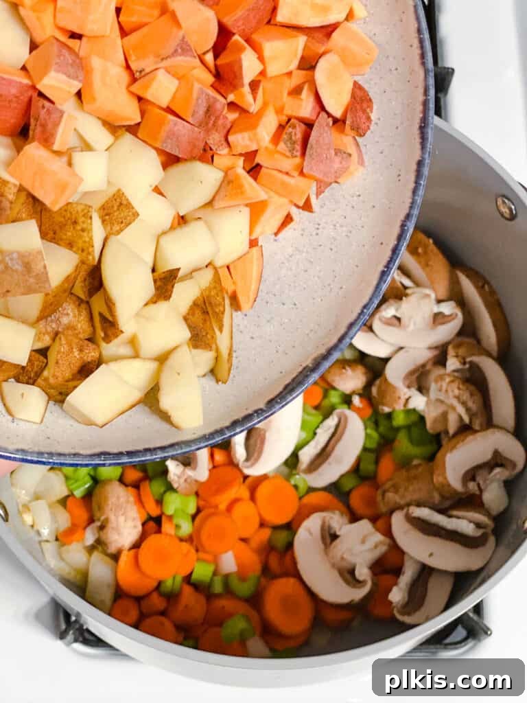 Comforting Red Lentil Stew 7 Assorted vegetables and red lentils combined in a large pot, ready for simmering into a hearty stew.