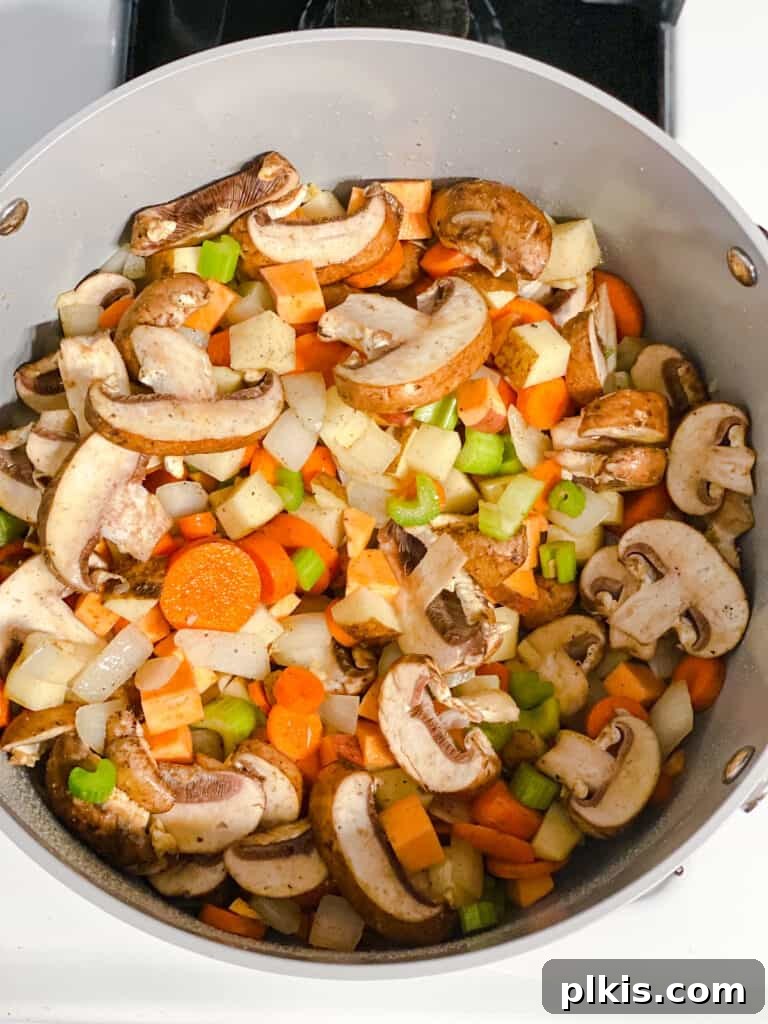 Comforting Red Lentil Stew 8 Process shot of vegetables cooking gently in a pot, forming the base of the lentil stew.