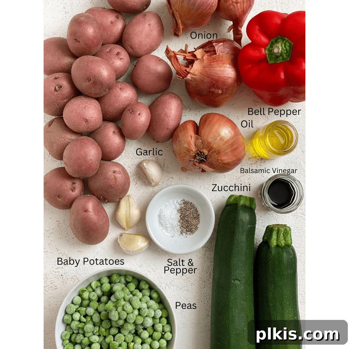 Vibrant Vegetable Sauté with Golden Baby Potatoes 3 Arrangement of fresh ingredients for Garlic Baby Potato Bowl, including various vegetables, garlic, and spices, laid out on a white surface.
