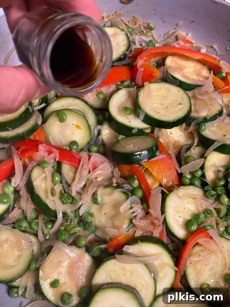 Vibrant Vegetable Sauté with Golden Baby Potatoes 9 Mixed vegetables cooking in a skillet, seasoned with balsamic vinegar.