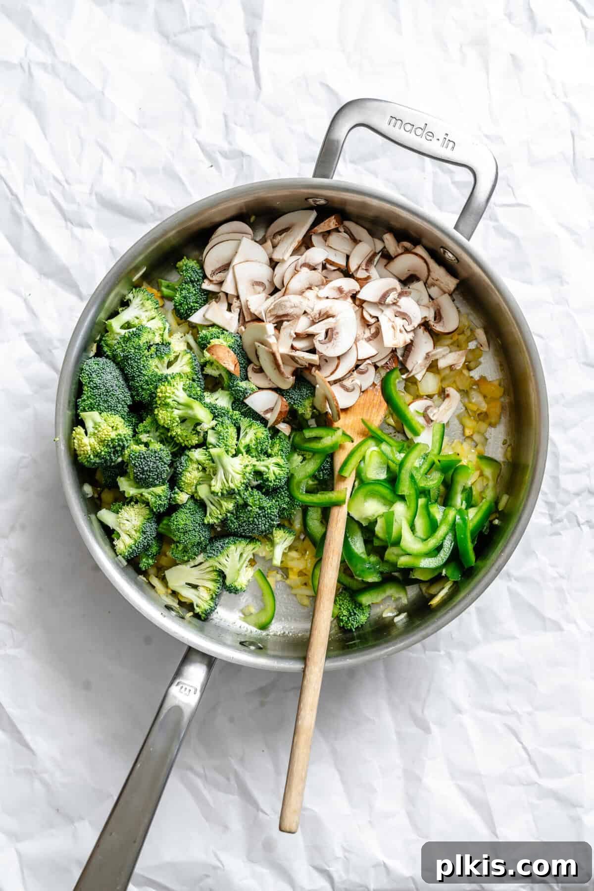 Vibrant Bean Sprout Curry 5 Process shot showing stirring Bean Sprouts Curry in a pot with vegetables and spices.