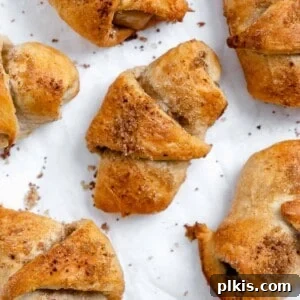 completed vegan apple crescents scattered on a white surface