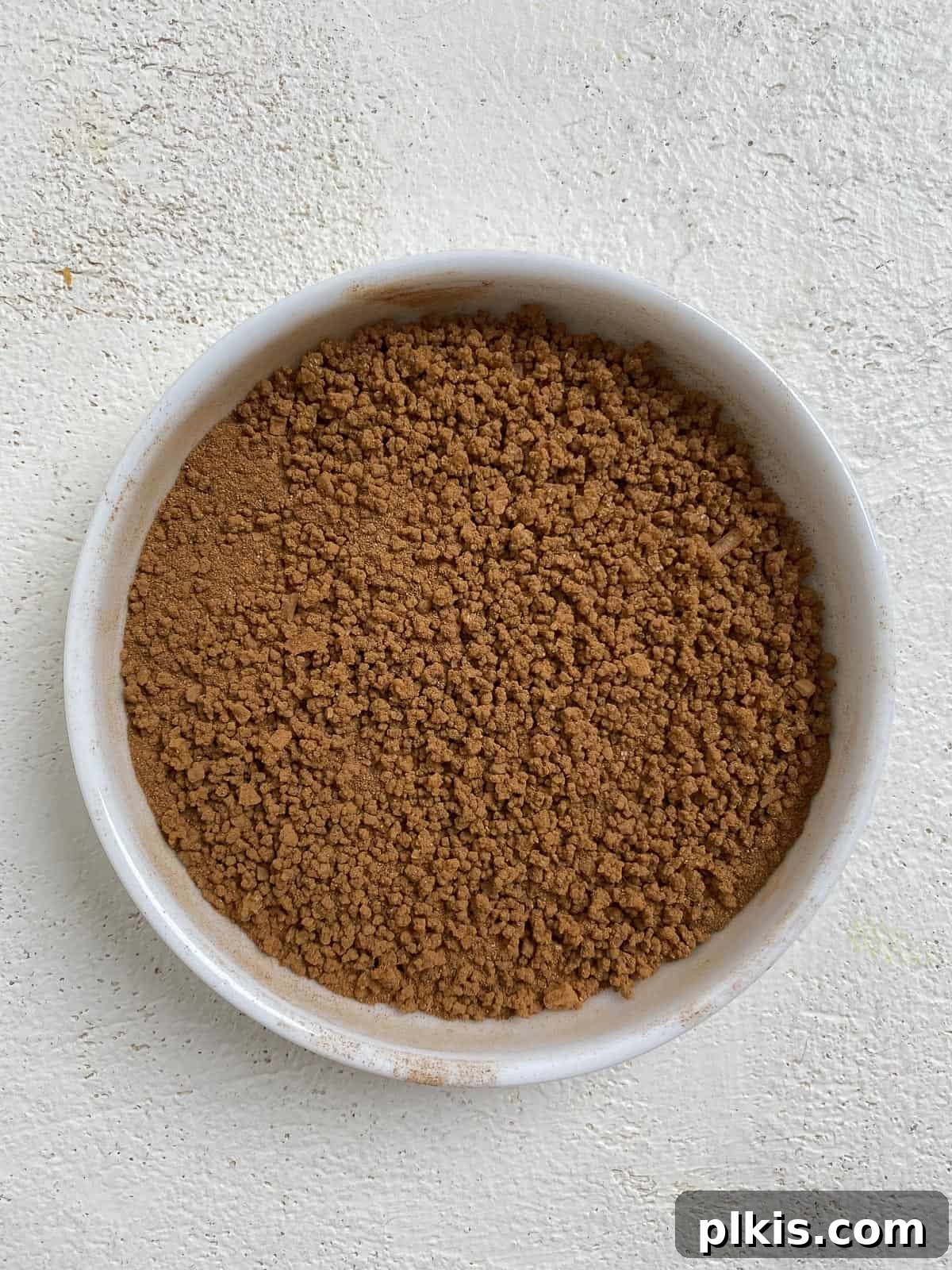 Golden Apple Cinnamon Crescents 8 The blended sugar, cinnamon, and salt mixture in a white bowl, ready for use.