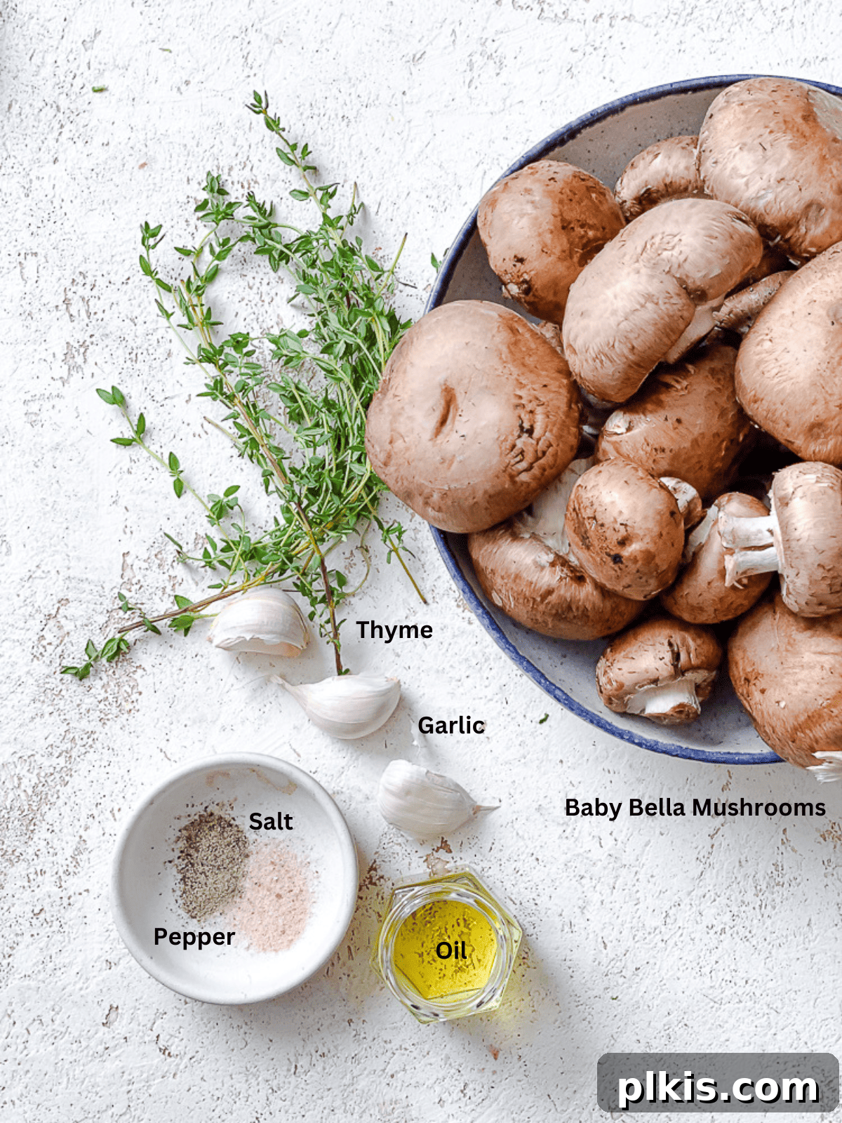 Sizzling Garlic Thyme Mushrooms 3 ingredients for Sauteed Mushrooms with Garlic and Thyme on a white surface