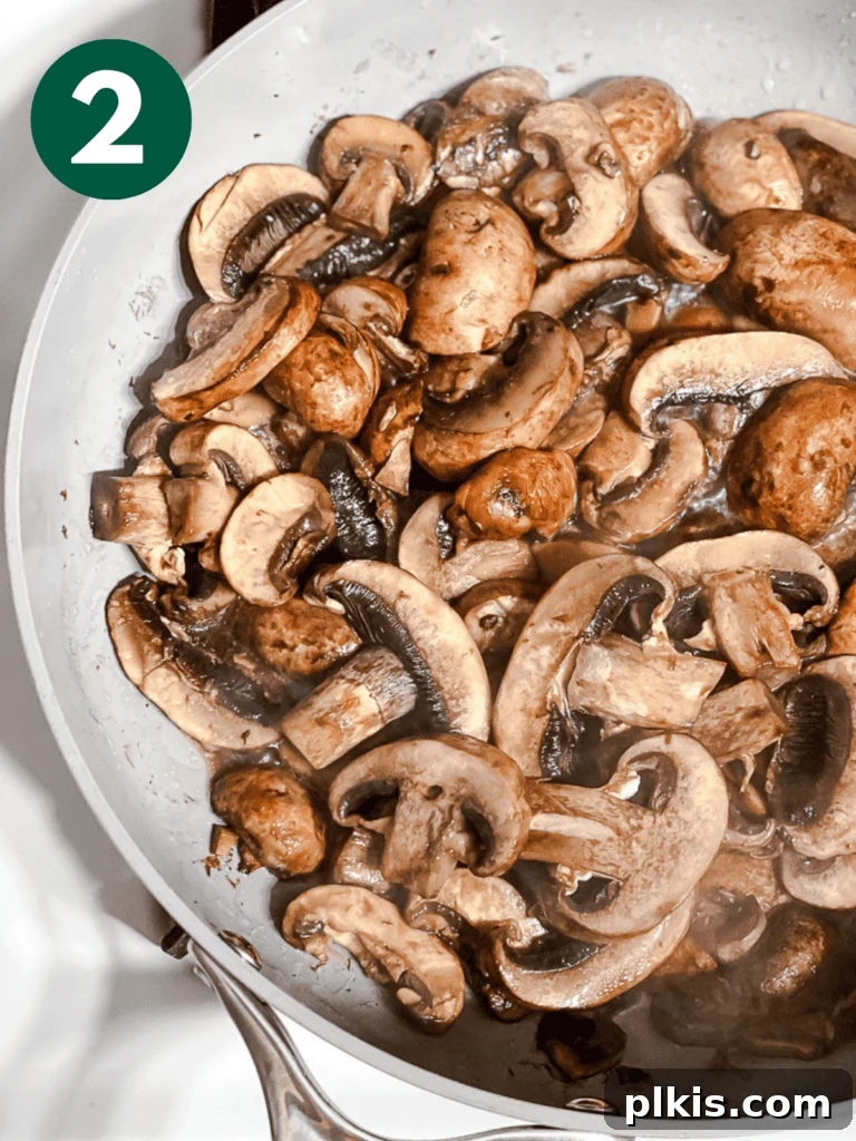 Sizzling Garlic Thyme Mushrooms 5 process shot of cooking mushrooms in a pan