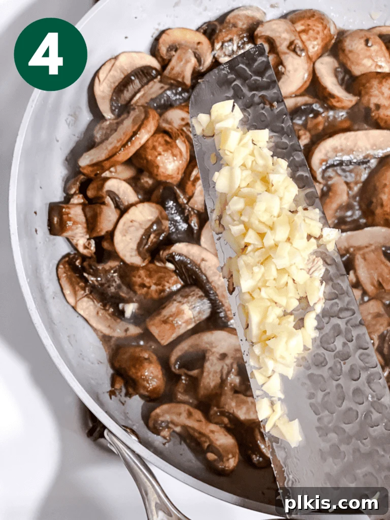 Sizzling Garlic Thyme Mushrooms 7 process shot of adding garlic to pan