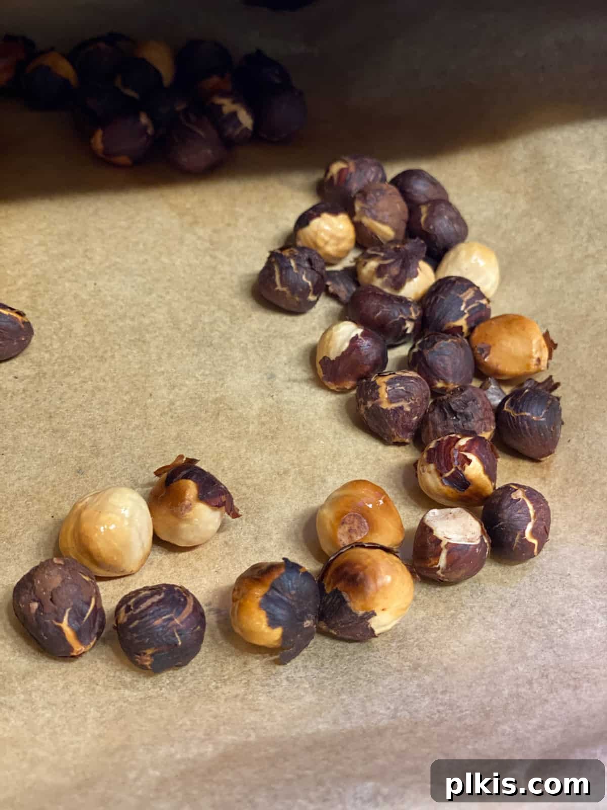 Golden Roasted Delicata Sweet Potato Soup 12 Toasted hazelnuts scattered on parchment paper