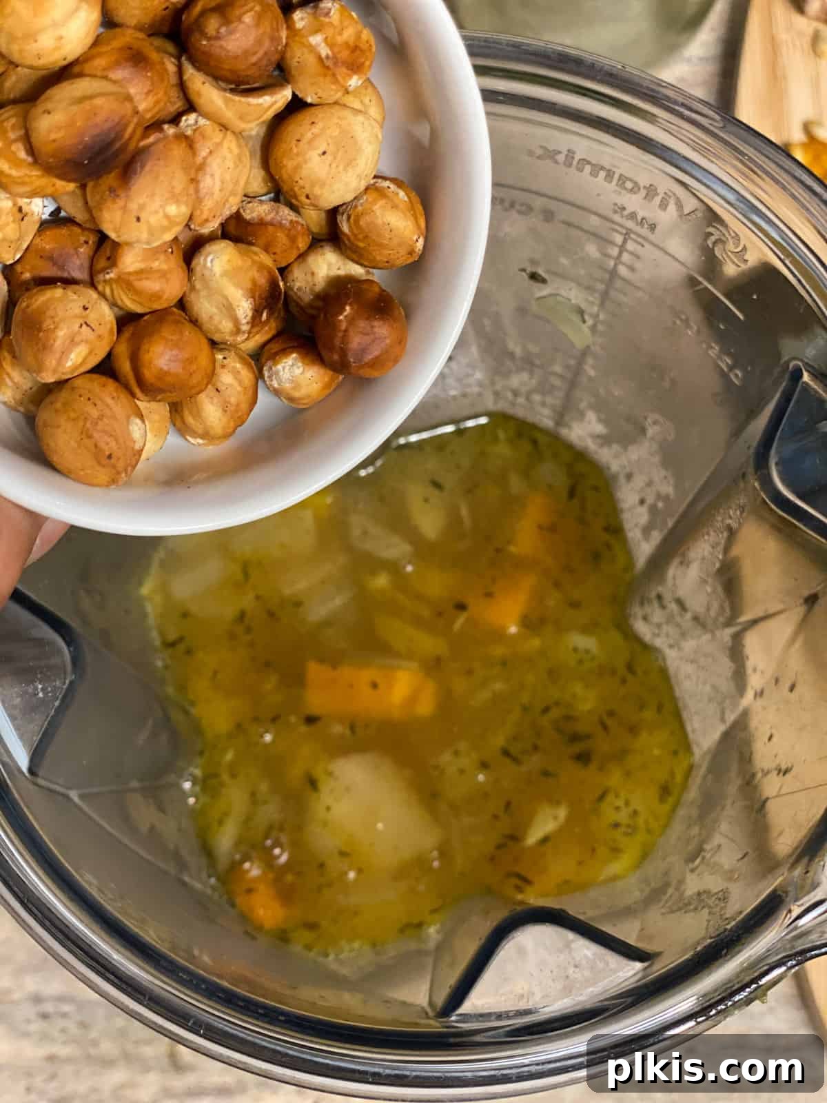 Golden Roasted Delicata Sweet Potato Soup 14 Process shot of adding toasted hazelnuts to the blender
